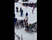 Woman in tube top poses beside the ski boards 