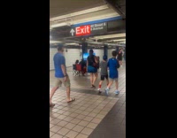 Couple plays video game at train station