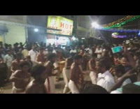 Group of shirtless men band plays drums in the street