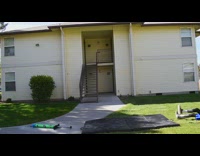Boy jumps high on pogo stick backflips and falls back on blue safety pad mat