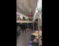 Pt. 2 Guy carries gray metal beam inside subway train