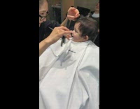 Baby boy gets haircut white cape lady 