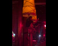 Man climbs up the pole of a lamp at the club