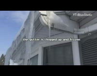 Guy breaks icicles hanging off roof shovel