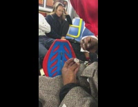 Red ripstick guy on subway taking bumps