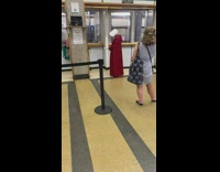 Person in red robe at post office