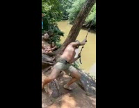 Guy swings tree holds on bellyflops