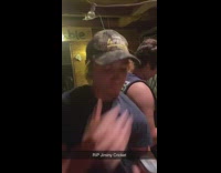 Man eats grasshopper with beer 