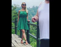 Girl poses by wood railing for photo