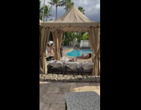 Lady in patterned bikini lays next to pool for photos 