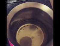 Guy fries shrimp chip in metal pot 