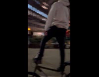 Man stands on bike ride at road