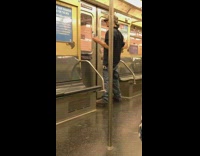 Man talks to himself in subway window reflection and hits window with water bottle