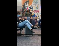 Girl grey cardigan dance inside airport  announcement