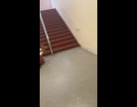 Girl slides down rail and falls off 