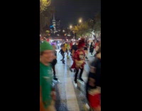 Crowd in costume roller skates on road