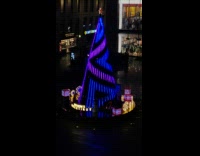 Lights Spin Around Christmas Tree in Plaza