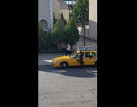 Green alien mascot ride taxi street church