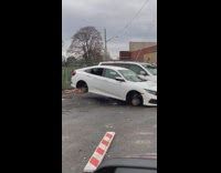 Car propped up on crate missing tires 