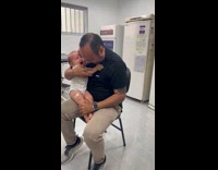 Dad holds baby cries during vaccine shot