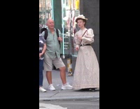 Woman vintage dress talks on the sidewalk