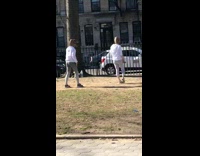 Two girls dance dinosaur costume head park