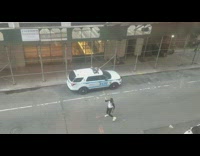 Guy dances to music next to NYPD 