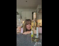 Woman waits to drink wine 