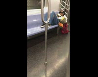 Guy lays back white bird chest subway 