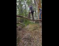 guy stands on tree branch falls on back