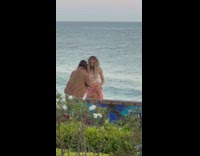 Woman in pink dress with roses poses with the beach view Part 2
