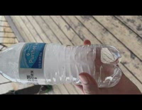 Guy shakes bottle water inside freezes ice 