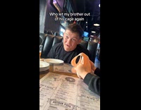 Guy makes faces at baby restaurant