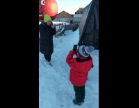 Girl scolds small boy for ruining her photo