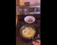 Guy succeeds flipping eggs in a skillet and says thats all hes got