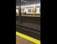 Woman stretching in subway station while waiting for train