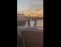 Girl plays violin badly friend sings beach  