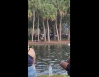 Woman leather pants ballet dance at the lake park