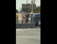 Guy practice juggles pin on the sidewalk