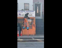 Collab WINY - Man Orange backgroud and pants on Stilt Dances Along with Music