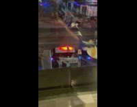 Tree women lean on police car night