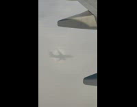 Shadow of airplane casted on the clouds