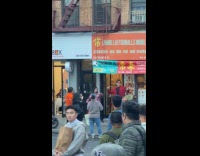 Man singing karaoke outside Chinese restaurant 