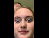 Pink shirt girl applies eyeliner on friend