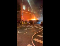 Firemen sprays water at big dumpster fire