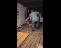 Guy loses balance while trying to crush beer cans