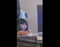 Little baby on computer with headphones on 