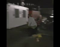 Guy in green shirt and blue flannel hikes and tackles down porta potty