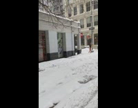 Bodysuit girl poses in snow by pole 