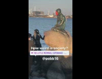 Girl black wetsuit green statue red mask 